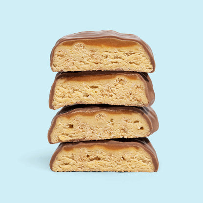 Coconut Crunch bars stacked with creamy coconut and caramel flavor, covered in delicious milk chocolate.